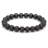 Elastisches Armband aus runden, glänzenden Perlen in tiefem Dunkelgrau auf weißem Hintergrund.