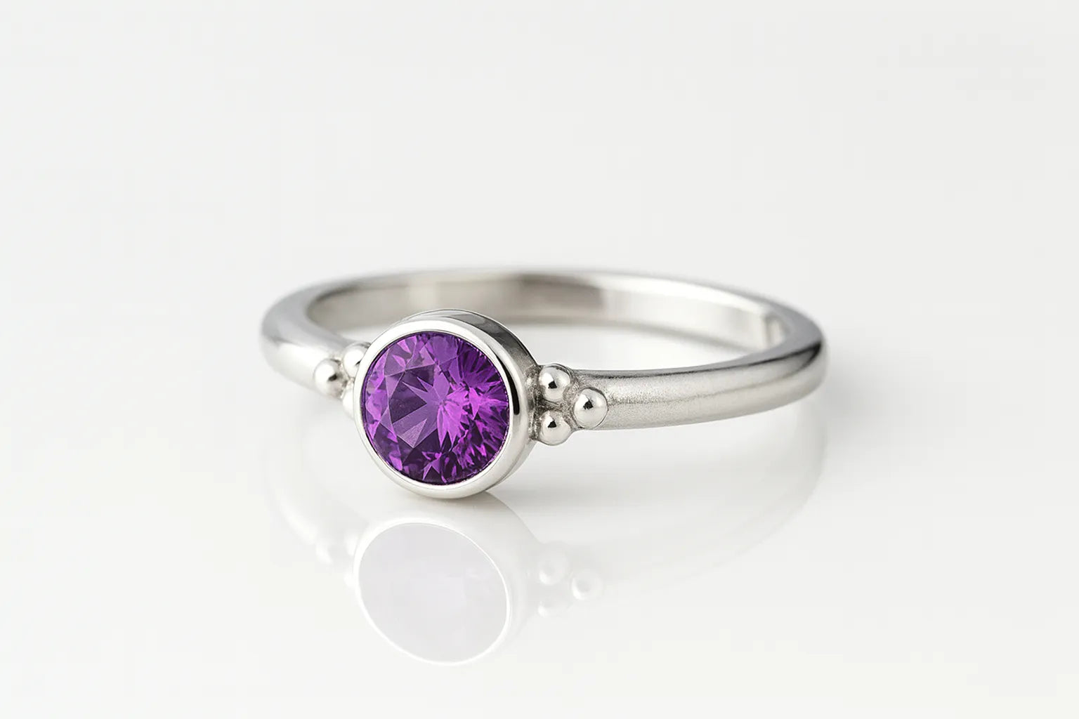Eleganter Silberring mit 4 mm rund facettiertem Amethyst in Zargenfassung und dekorativen Silberkügelchen, Sterling Silber 925, Produktfoto Schmuck.