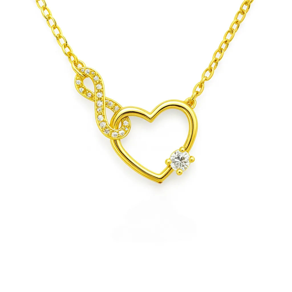 Vergoldete Damen Halskette mit offenem Herz und Infinity-Symbol, besetzt mit klaren Zirkonia und rundem Solitärstein, romantische Liebeskette auf weißem Hintergrund.