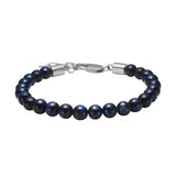 Herrenarmband mit runden Perlen aus blauem Tigerauge und Edelstahlverschluss, ein natürlich-elegantes Schmuckstück für stilbewusste Männer.