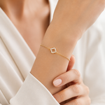 PamelaNor Armband aus vergoldetem 925 Silber mit funkelndem Kleeblatt-Motiv, elegant am Handgelenk getragen.