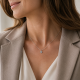 SigneNor Elegante Damenhalskette aus 925 Silber mit Kleeblatt-Anhänger zu hellem Blazer und cremefarbener Bluse.