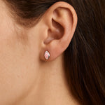 Nahaufnahme eines Ohrs mit einem eleganten Ohrstecker aus Sterlingsilber, gefasst mit einem zarten, rosafarbenen Rosenquarz-Cabochon in marquiseförmigem Schliff. Der sanfte Glanz des Steins verleiht dem Schmuckstück eine feminine und edle Ausstrahlung.